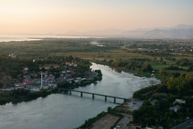 River flowing under a bridge in Shkodra town at dusk