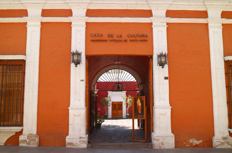 Orange facade and arched entrance of the Museo Santuarios Andinos in Arequipa