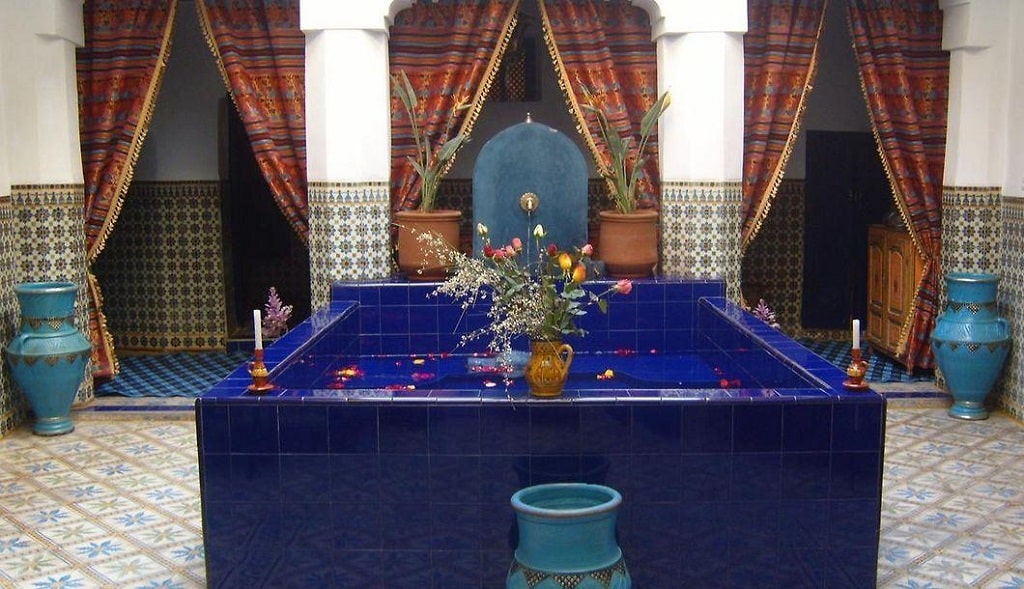 A square-shaped fountained made of blue tiles at a riad boutique hotel in Marrakech
