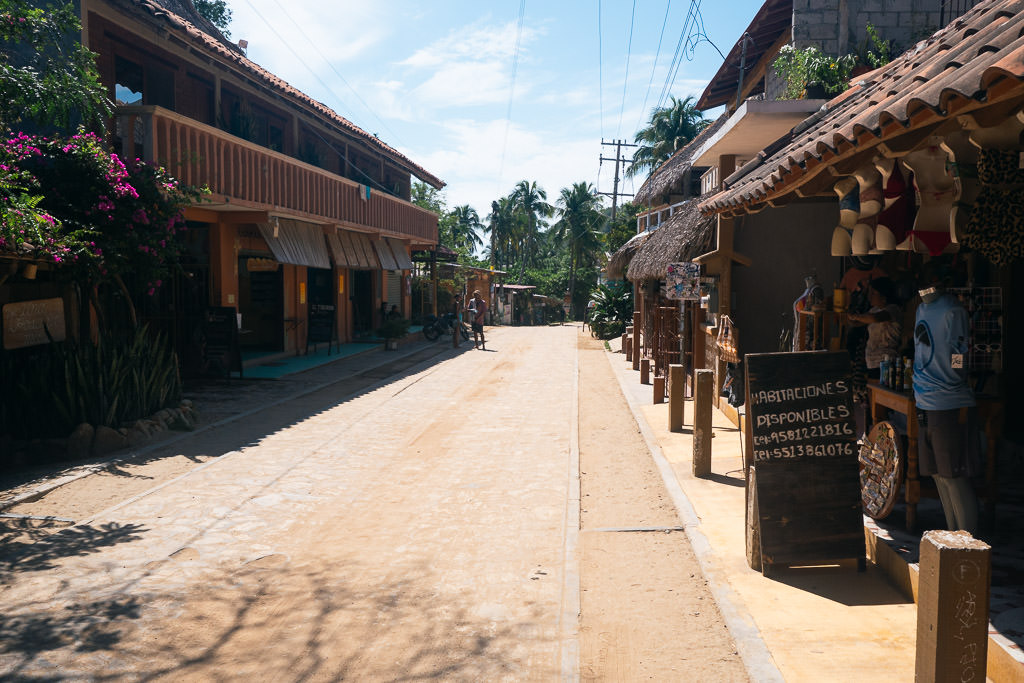 A road in Mazunte with stores at the sides.