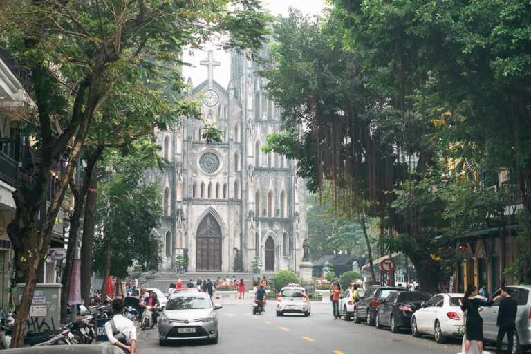 a view of St. Joseph's Cathedral famed by trees in Hanoi