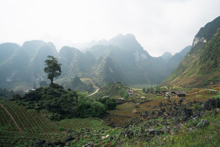 An expansive, misty view of the Hà Giang landscape