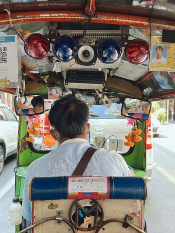 A man driving a tuktuk in Bangkok, Thailand.