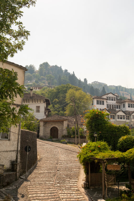 A cobblestone street winds through Gjirokastër’s Old Town