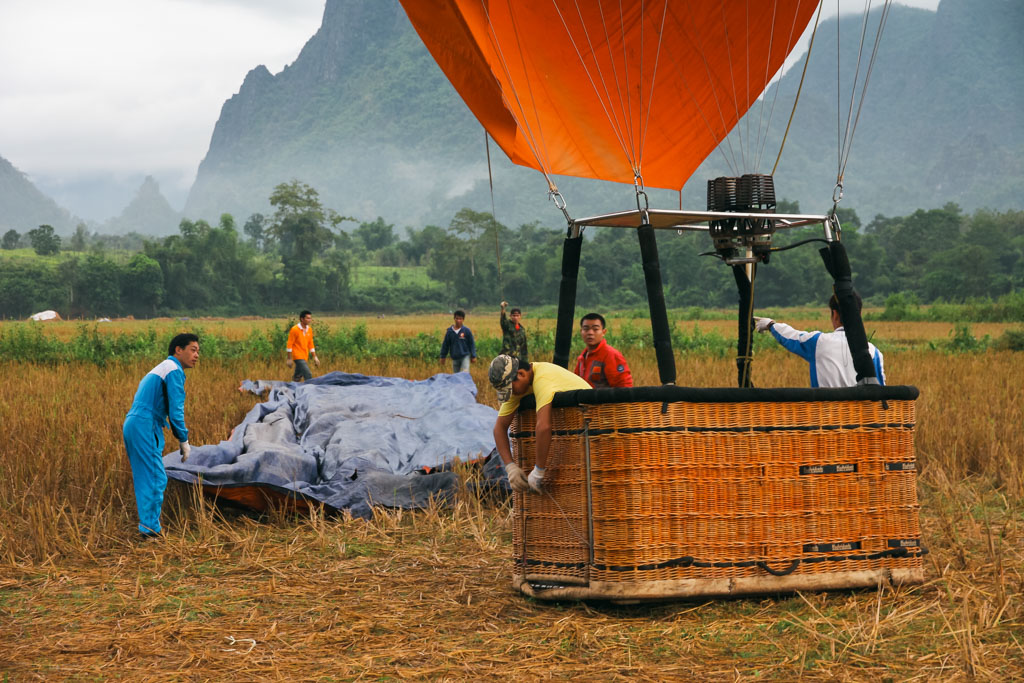 Men preparing a hot air balloon for take off.