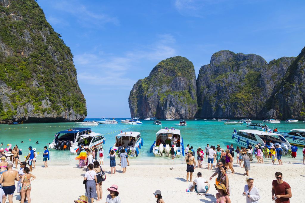 Tourists on Phi Phi Island beach in Thailand.