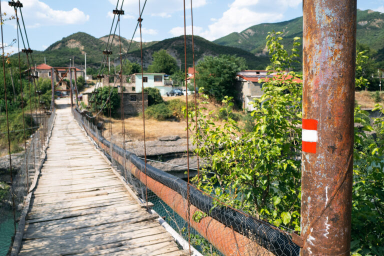 Rustic wooden suspension bridge near Petran
