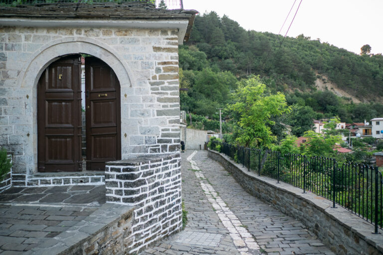 Cobbled street in Permet old town lined with a traditional stone building