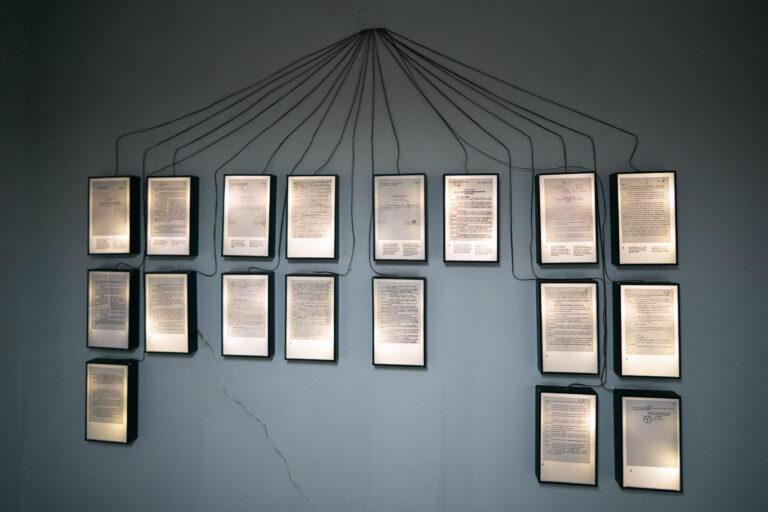 document panels clustered on a gray wall in the House of Leaves