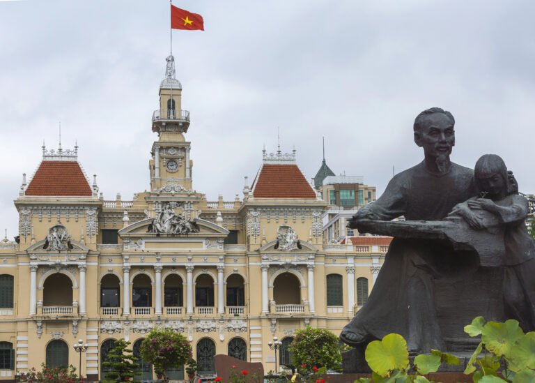 view of Ho Chi Minh City Hall with the HCMH statue in the foreground
