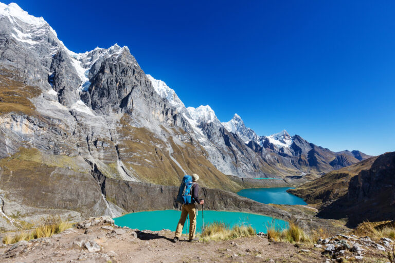 A hiker stands by the tres lagunas
