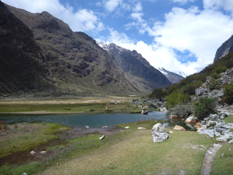 Grassy meadow and lake along the Santa Cruz Trek in the Cordillera Blanca