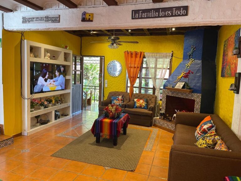 Bright living room at Casa Villas Suizas, featuring a firepit, lounge area, and TV setup