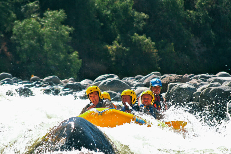 group of people whitewater rafting on the Chili River