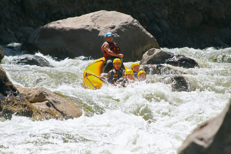 group of people whitewater rafting on the Chili River