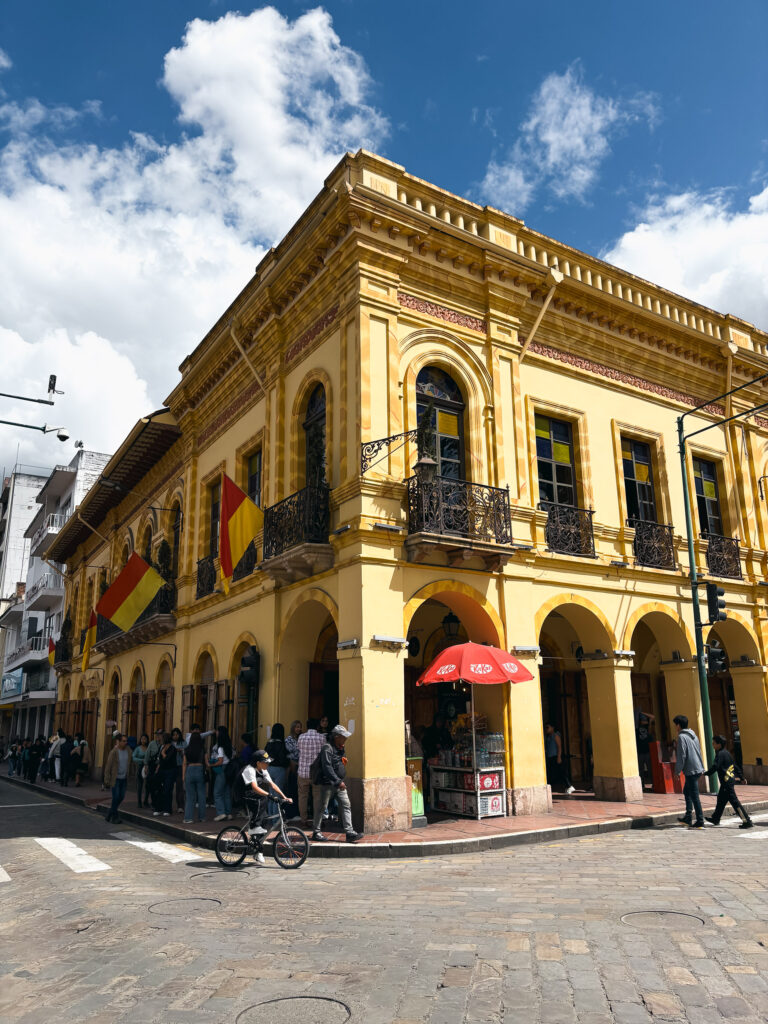 Corner view of Casa del Parque on a cobblestone street in Cuenca